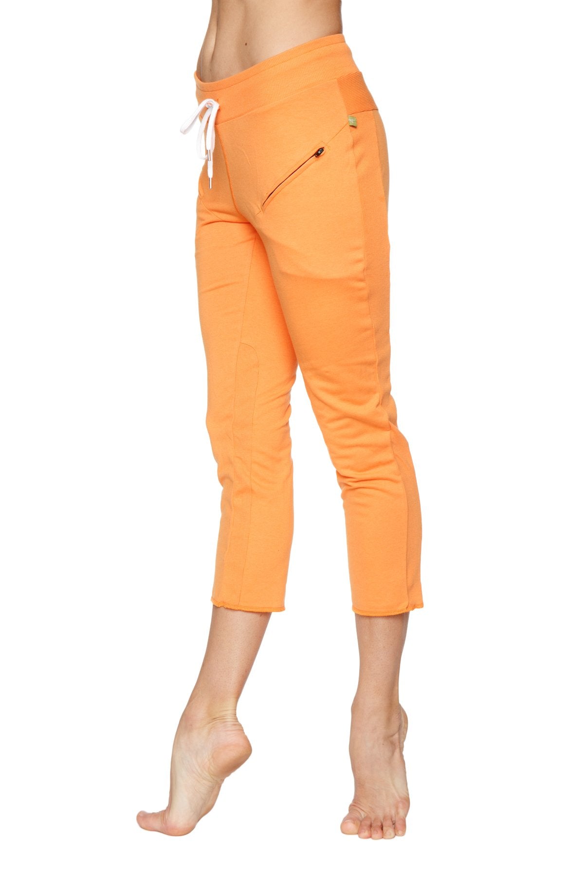 Women’s sun orange 4/5 length capri yoga pants with white drawstring waistband and zippered side pocket