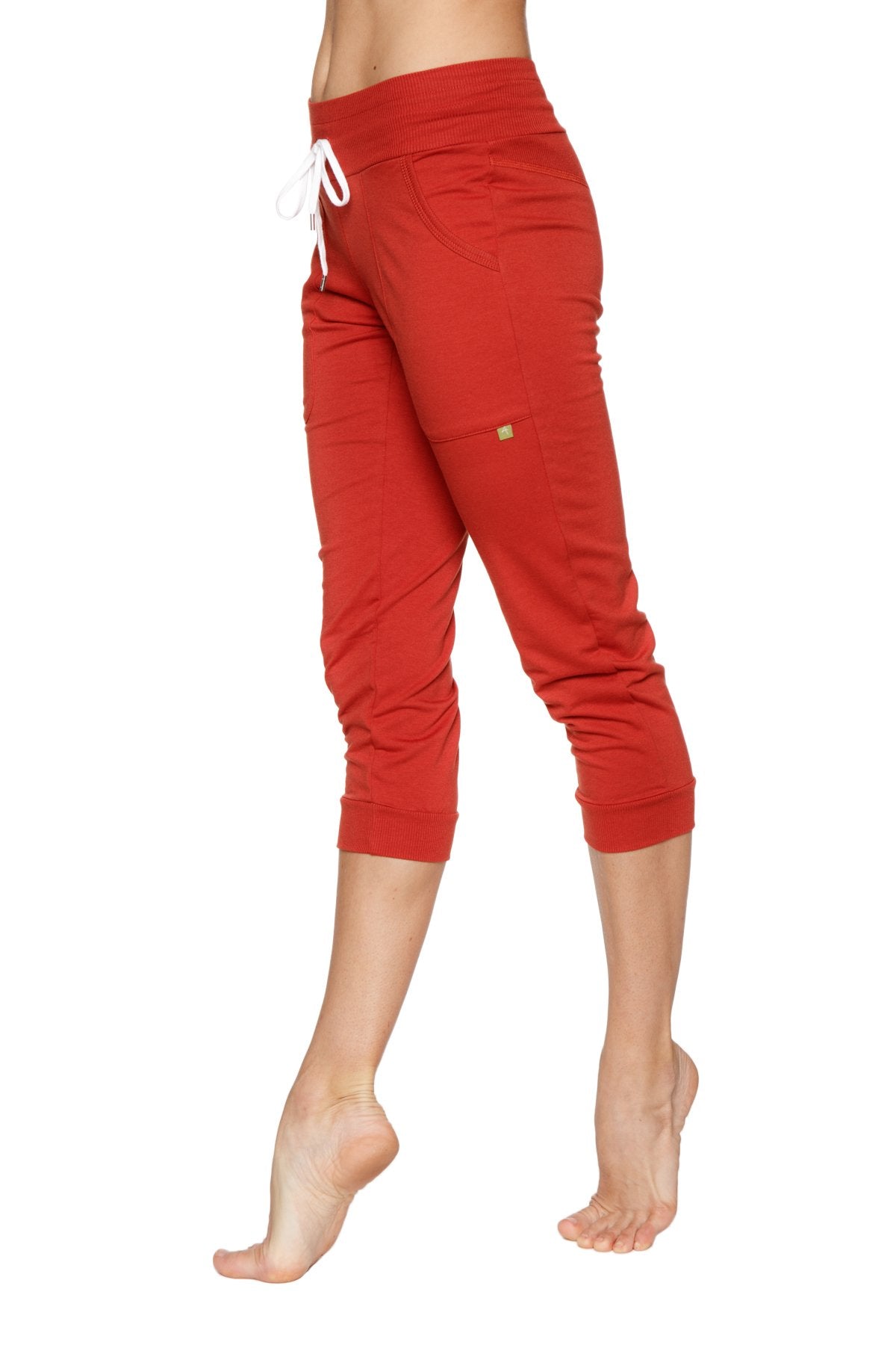 Women’s cuffed jogger yoga pant cinnabar in red with white drawstring waistband and elastic cuffed capri-length legs