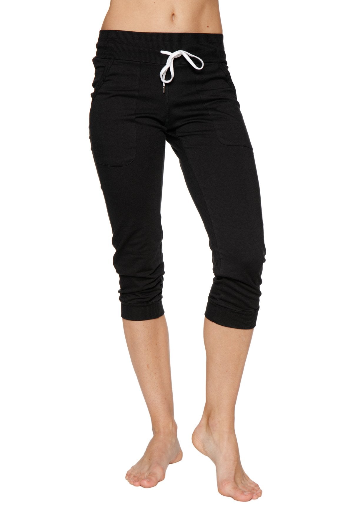 Women’s solid black cuffed jogger yoga pant with white drawstring waistband in capri length for athletic use