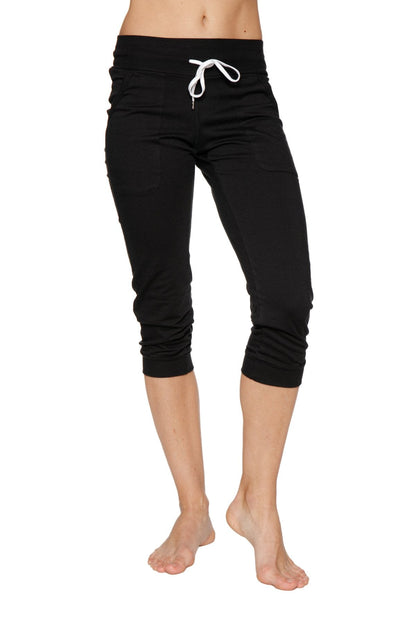 Women’s solid black cuffed jogger yoga pant with white drawstring waistband in capri length for athletic use