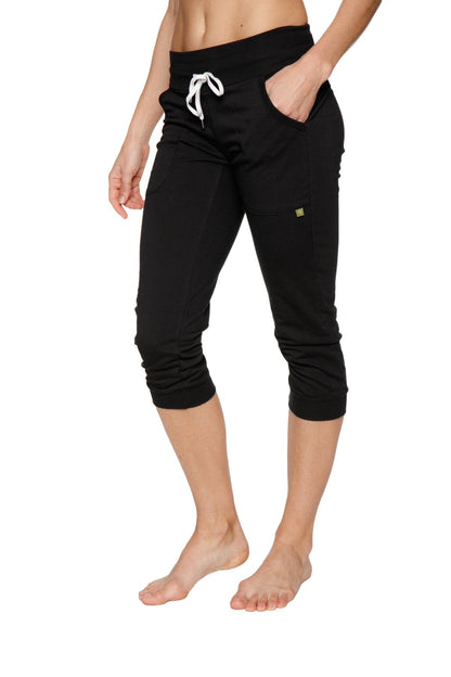 Women’s cuffed jogger yoga pant in solid black with white drawstring waistband and side pockets in capri length