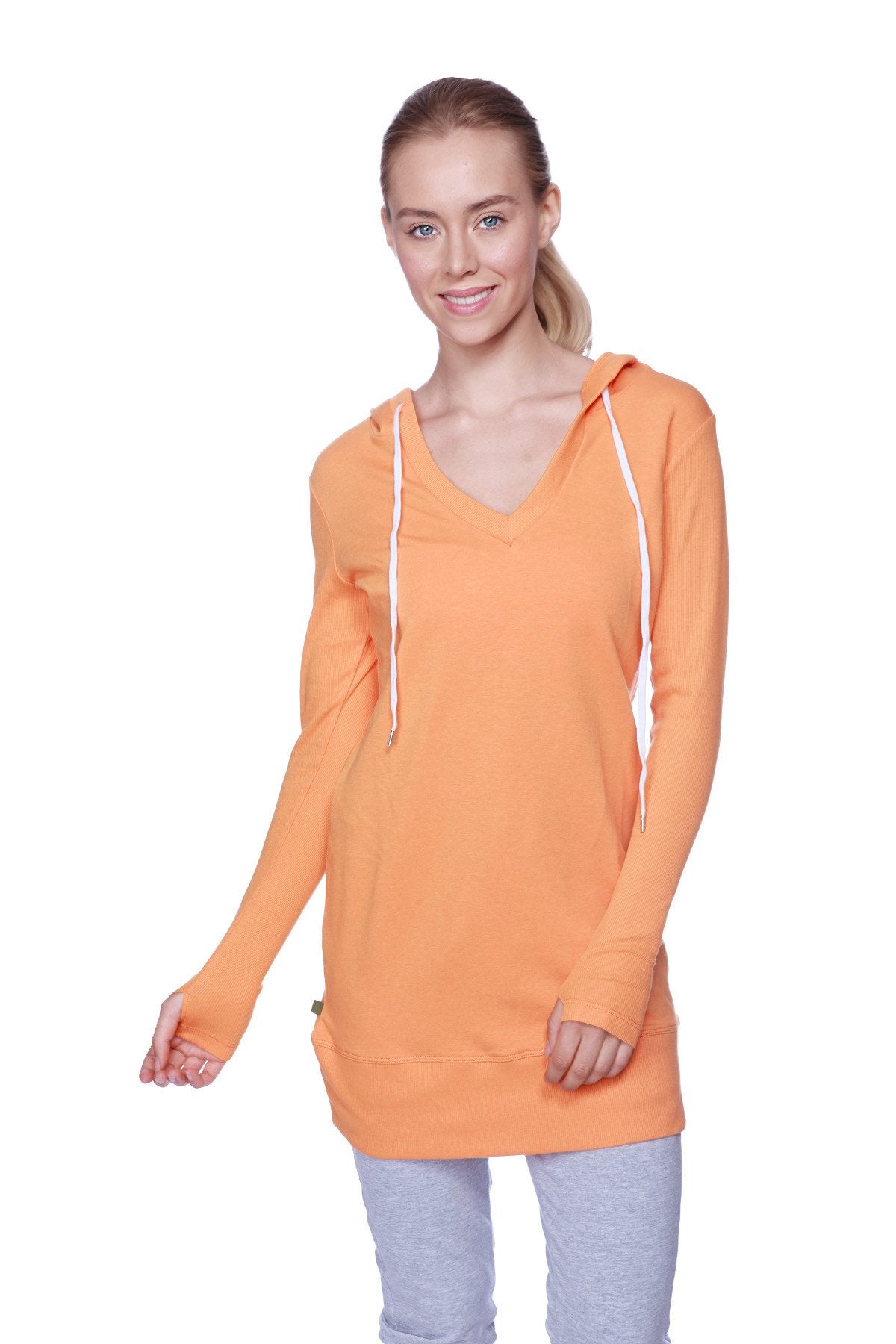 Women’s long body hoodie top in solid sun orange with white drawstrings and v-neckline long sleeves