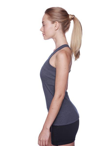 A woman wearing dark gray sleeveless tank top and black women’s performance yoga shorts for active use