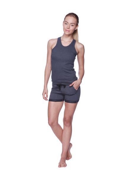 A woman wearing dark gray sleeveless performance yoga shorts with black drawstring waistband for active use