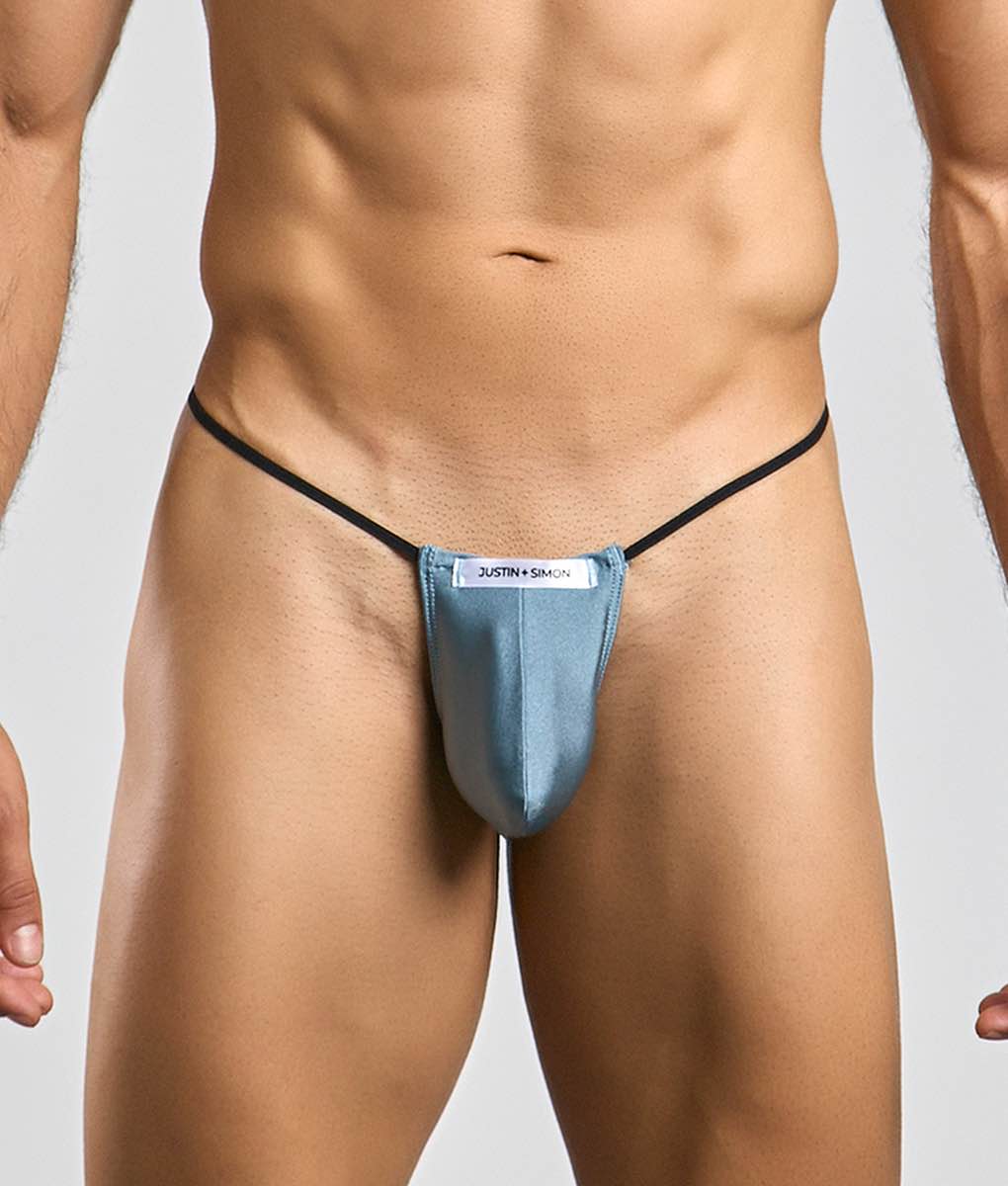 Blue justin + simon classic g-string bulge thong with black elastic straps shown from the back side