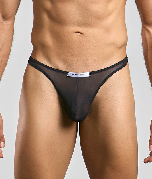 Black sheer mesh thong with a white justin simon label at the waistband from the classic tanga mesh collection