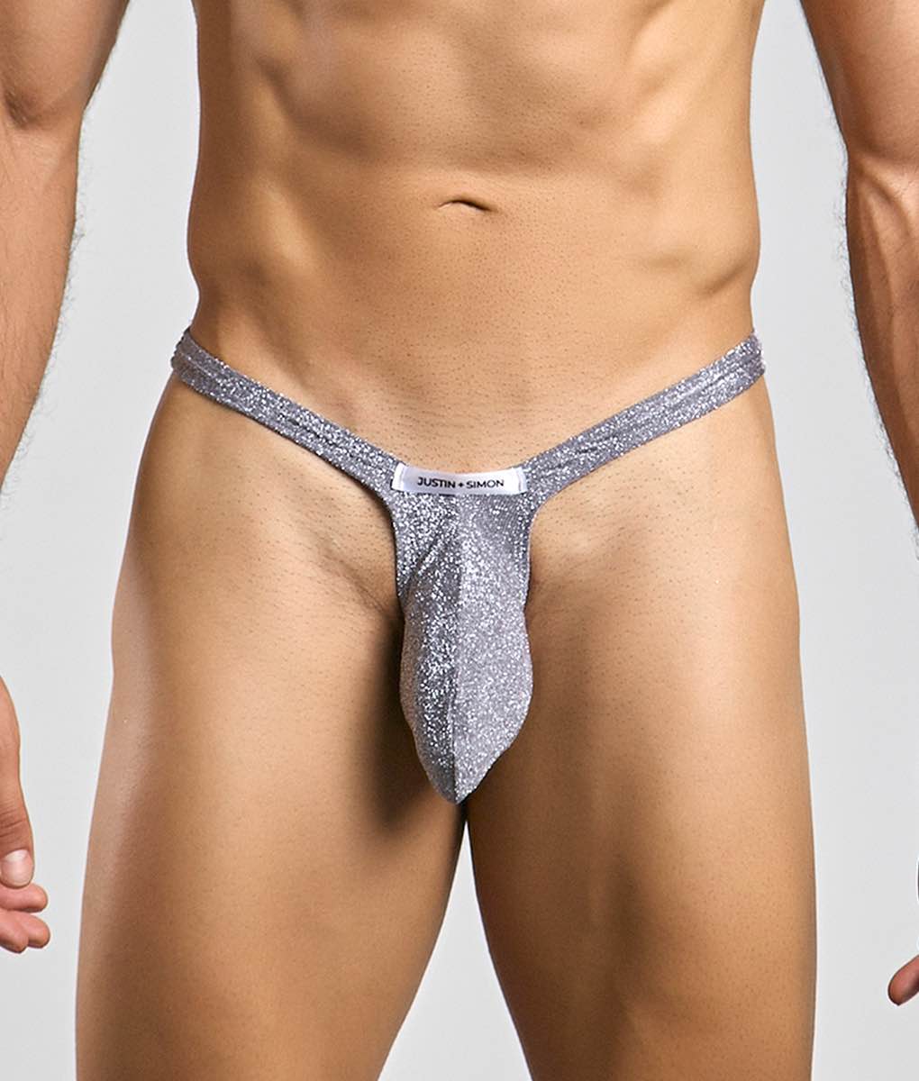 Silver glittery bulge thong with a white justin plus simon label at the front for bold stylish wear