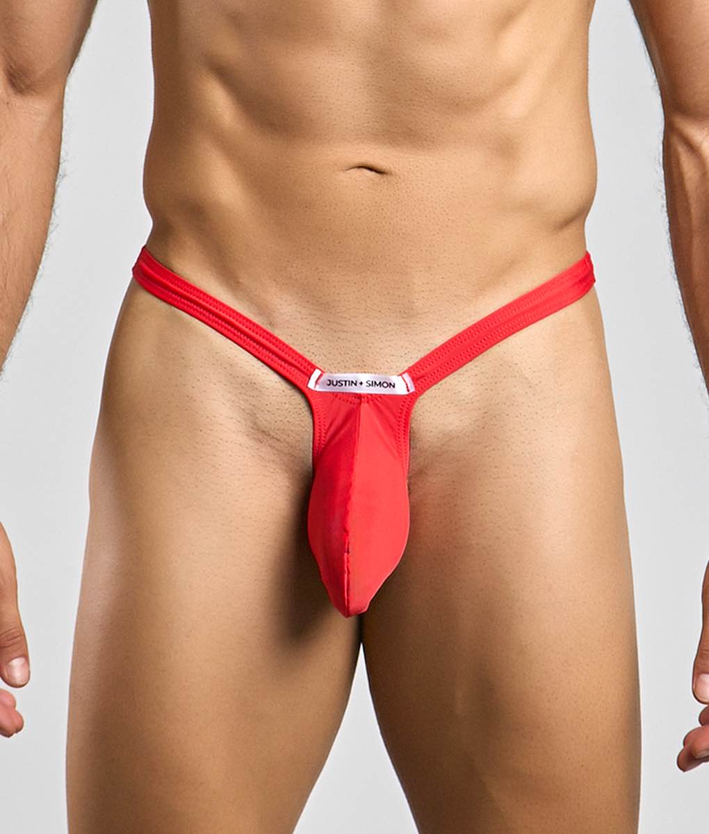Red justin simon bulge thong with sleek form-fitting design and white brand tag at front