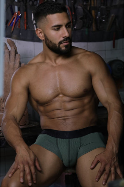 A pair of xtremen 91252 microfiber mesh trunks in military green with a black elastic waistband and form-fitting design
