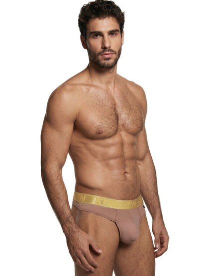 Xtremen beige thong with a metallic gold branded waistband on a muscular man.