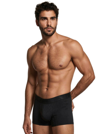 Xtremen black boxer briefs with a subtle hexagonal pattern and branded waistband on a muscular man.