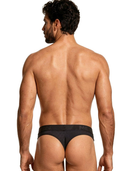 Xtremen black thong for men with a branded elastic waistband, featuring a fitted, textured fabric design.