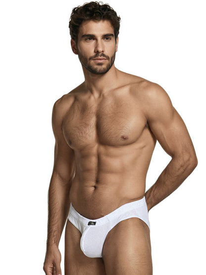 Xtremen white bikini brief with textured honeycomb pattern and logo tab, worn by a muscular man.