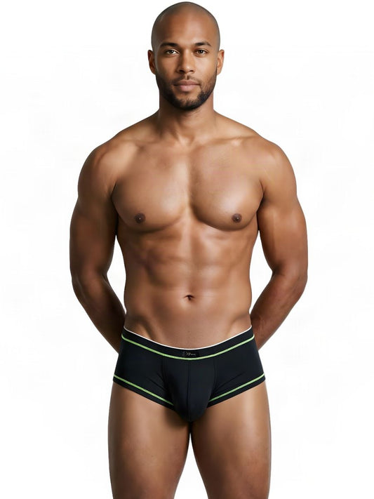 A model wears black athletic microfiber briefs with lime green trim, standing facing forward against a white background.