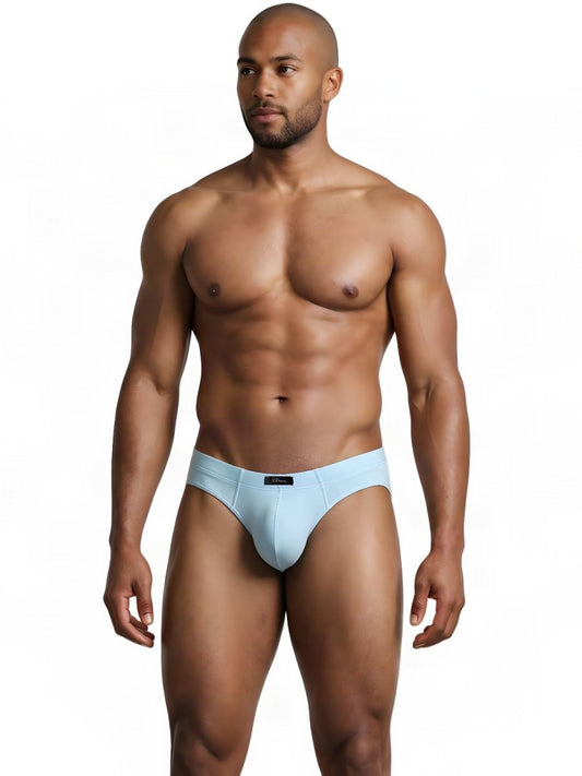 A man wearing light blue sleek fit briefs, standing against a white background.