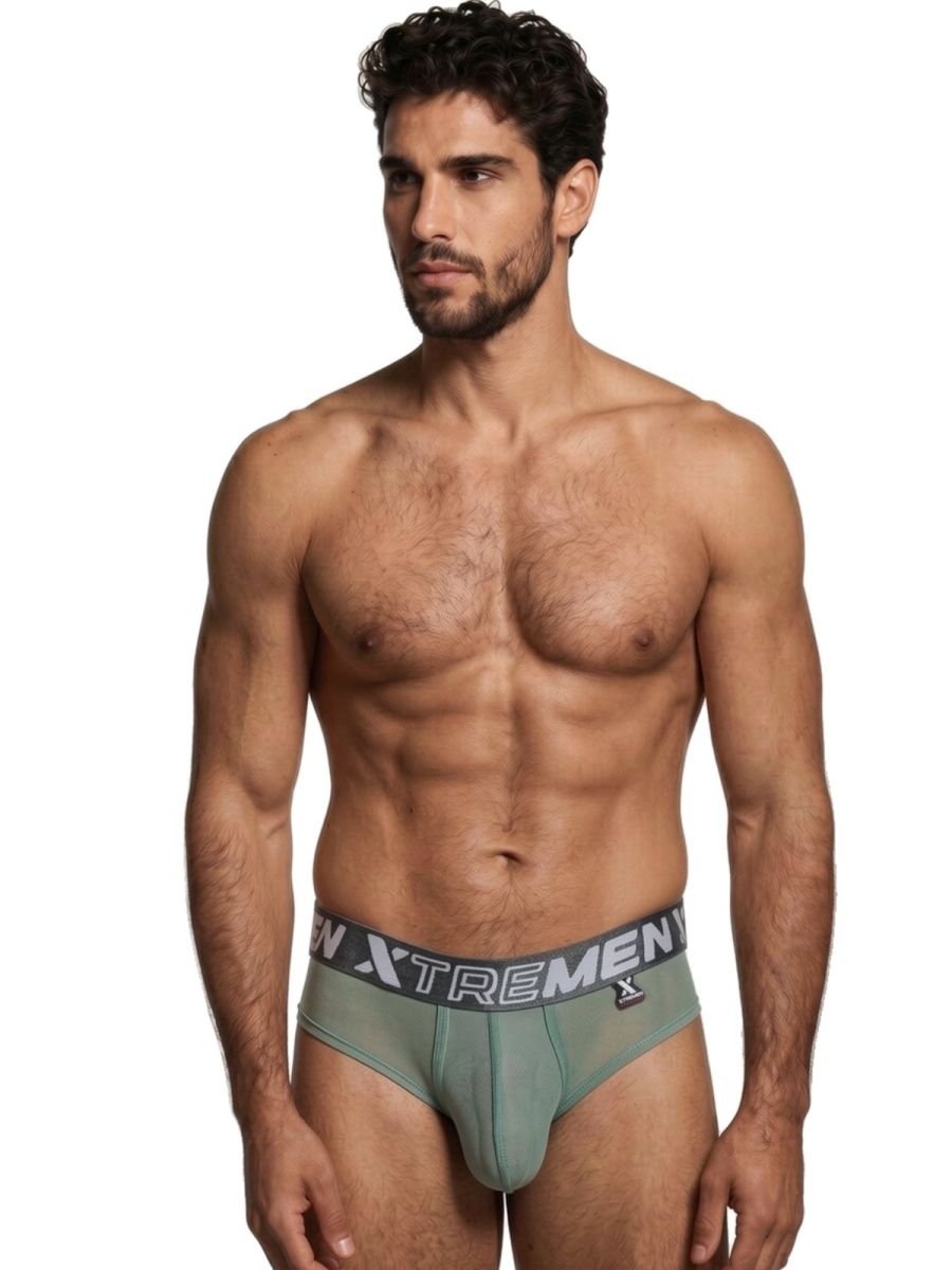 Xtremen olive green bikini briefs with a branded elastic waistband and sheer, form-fitting fabric on a male model.