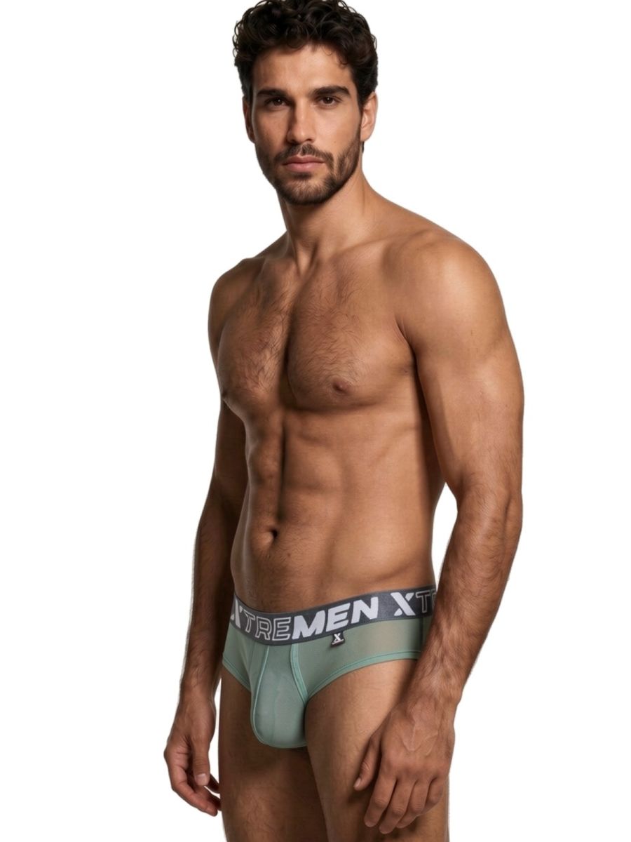 Xtremen sage green sheer bikini brief with a grey branded waistband on a fit male model.