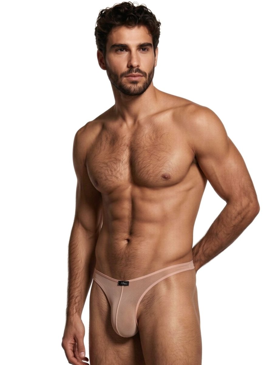 Xtremen beige sheer mesh thong with a form-fitting pouch and minimalist design on a male model.