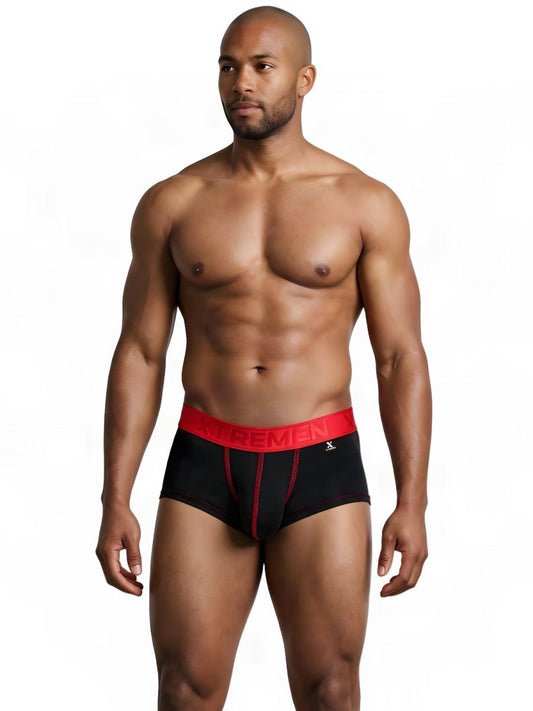 A muscular man wearing black athletic briefs with a red waistband and red stitching.