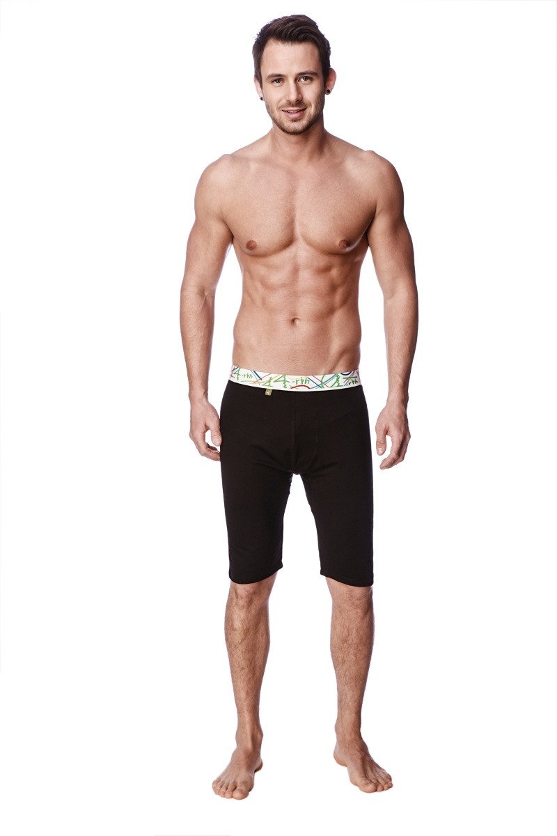 Black yoga compression shorts with decorative green and white patterned waistband designed for support and comfort