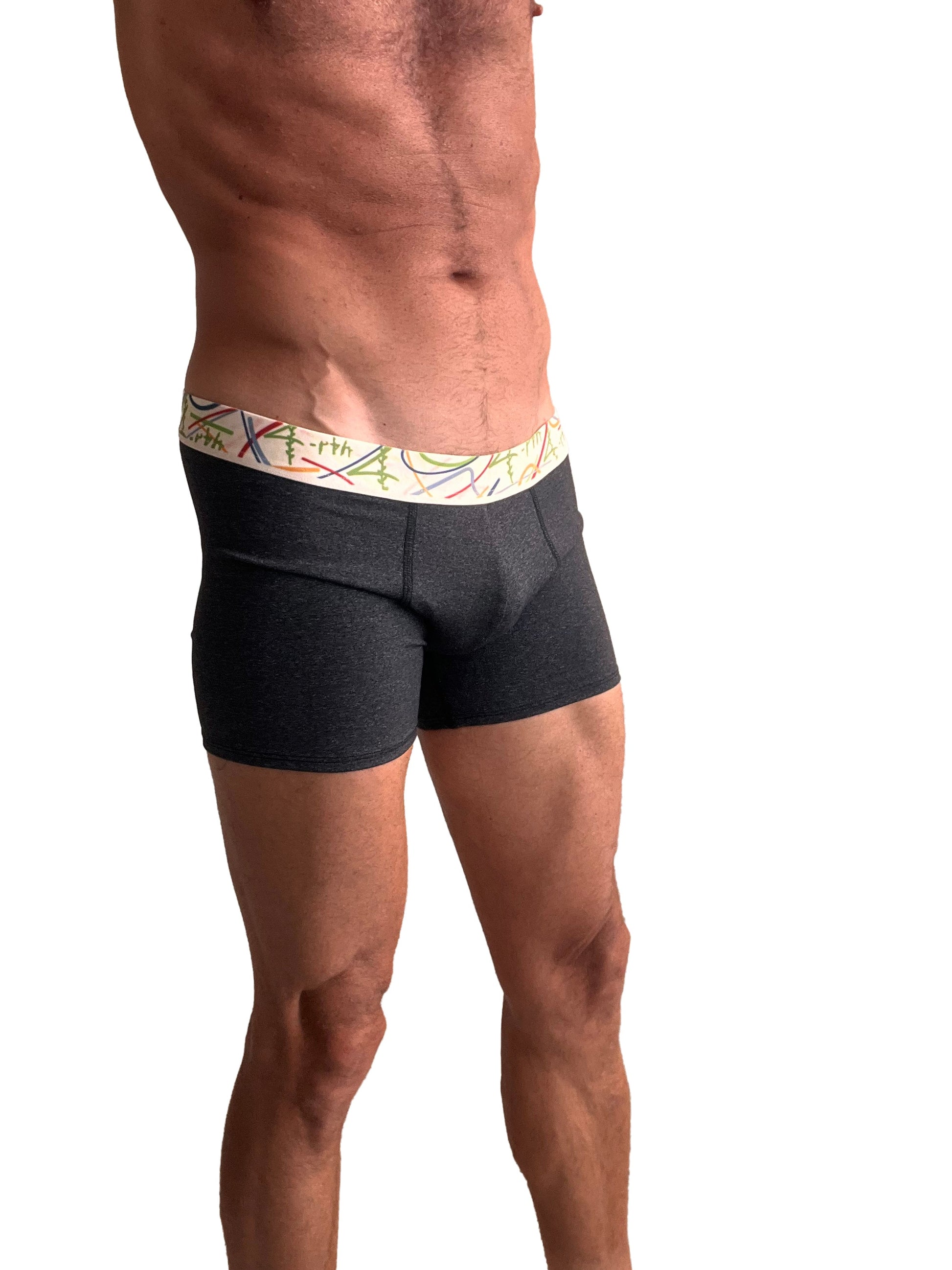 Black textured zen boxer brief with colorful abstract waistband and green earth logo in charcoal grey