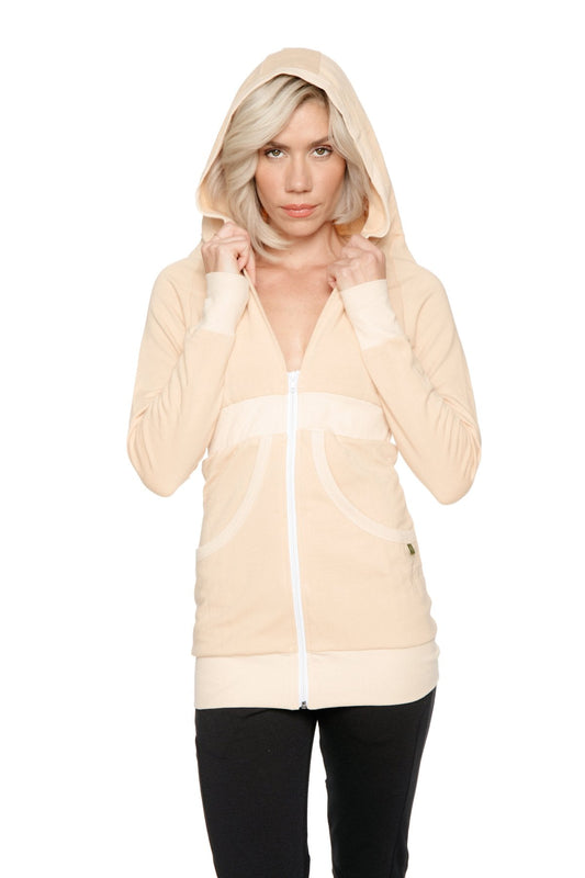 Cream-colored zip-up long body travel hoodie jacket with white trim along zipper cuffs and hem in sand beige