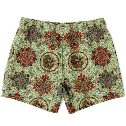Colorful mosaic-patterned swim shorts by Maris Equi featuring intricate floral and geometric designs on a light green background.