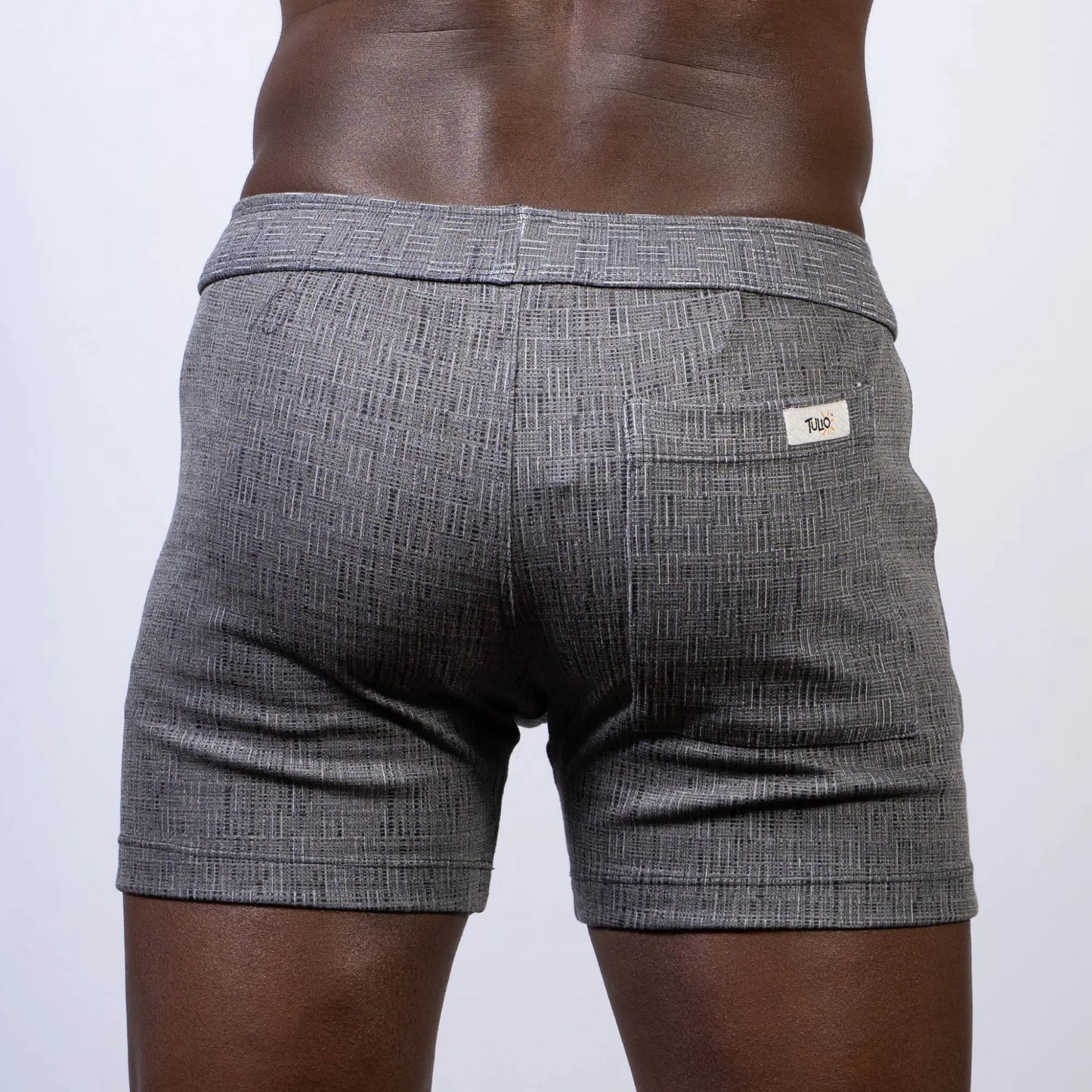 Gray textured abstract linen texture shorts with subtle herringbone pattern and white brand tag on back waistband