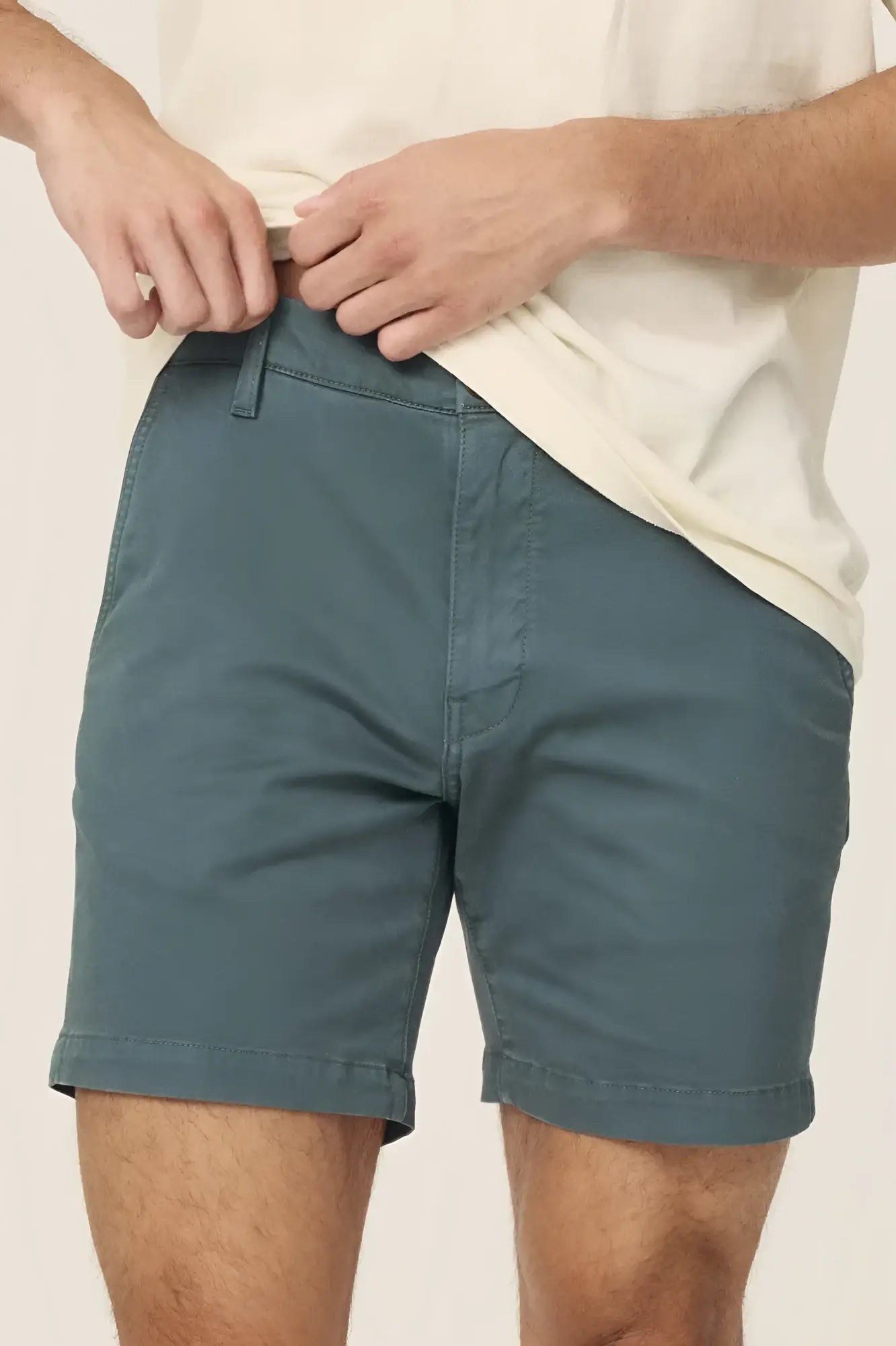 Men’s teal act chino shorts with classic fit rolled cuffs made from lightweight breathable fabric