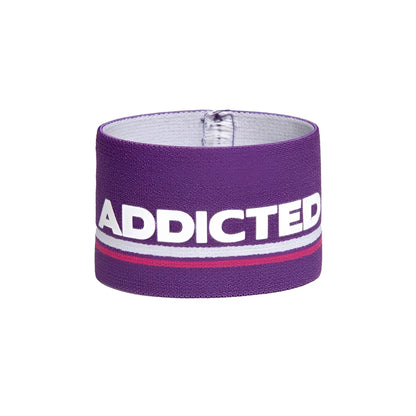Purple elastic wristband bracelet with bold white addicted lettering and a thin red stripe size one size