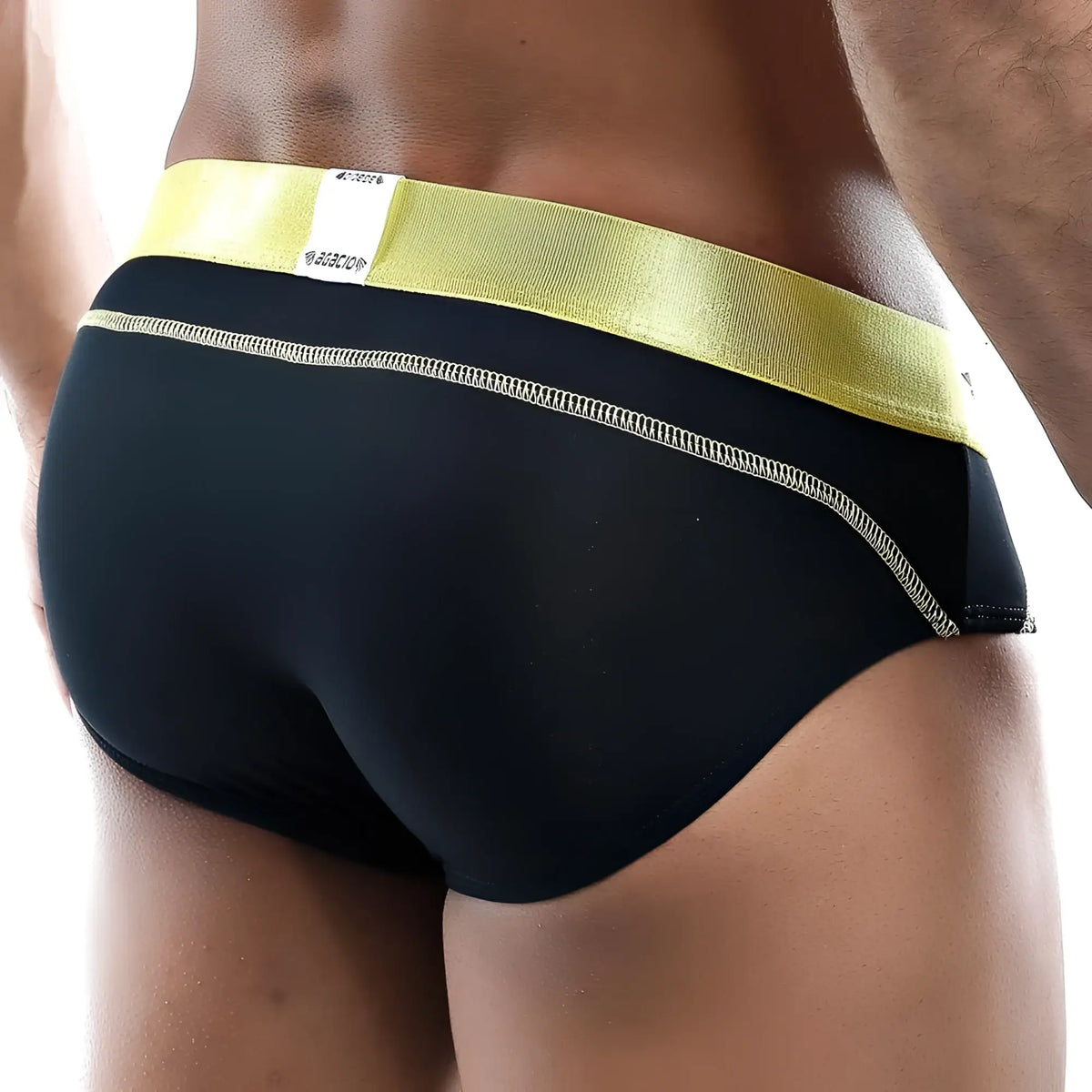 Black Agacio AGJ013 brief with shiny yellow waistband and white stitching along the side seam