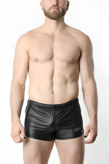 Black shiny faux leather anti-chrome gear short with subtle logo on the lower right leg front view