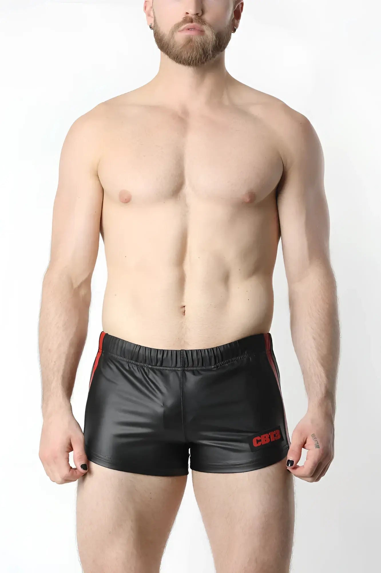 Black shiny faux leather anti-chrome gear shorts with red side stripes and embroidered logo on the left leg