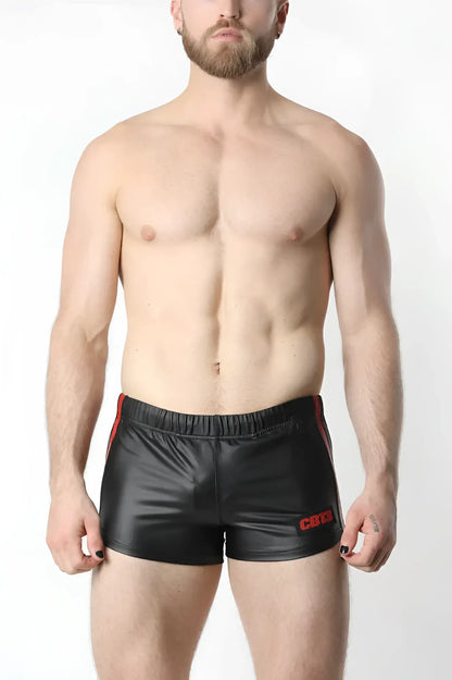 Black shiny faux leather anti-chrome gear shorts with red side stripes and embroidered logo on the left leg