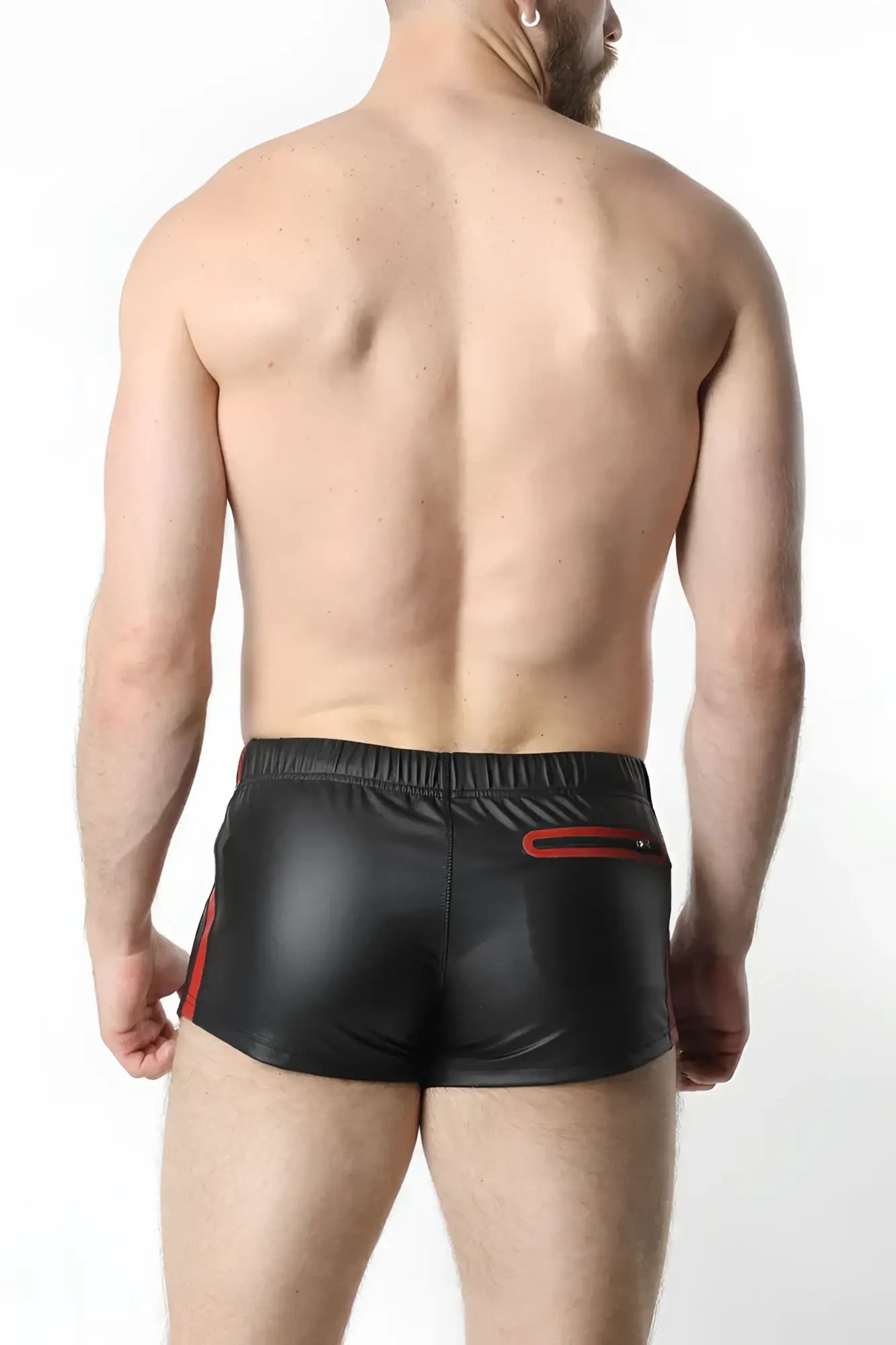 Black shiny faux leather anti-chrome gear shorts with red side stripes and back zipper pocket shown from the back