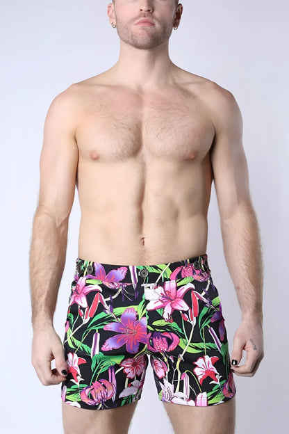 Balboa hybrid swim short featuring vibrant floral-patterned swim trunks in bold pink purple and green on black background