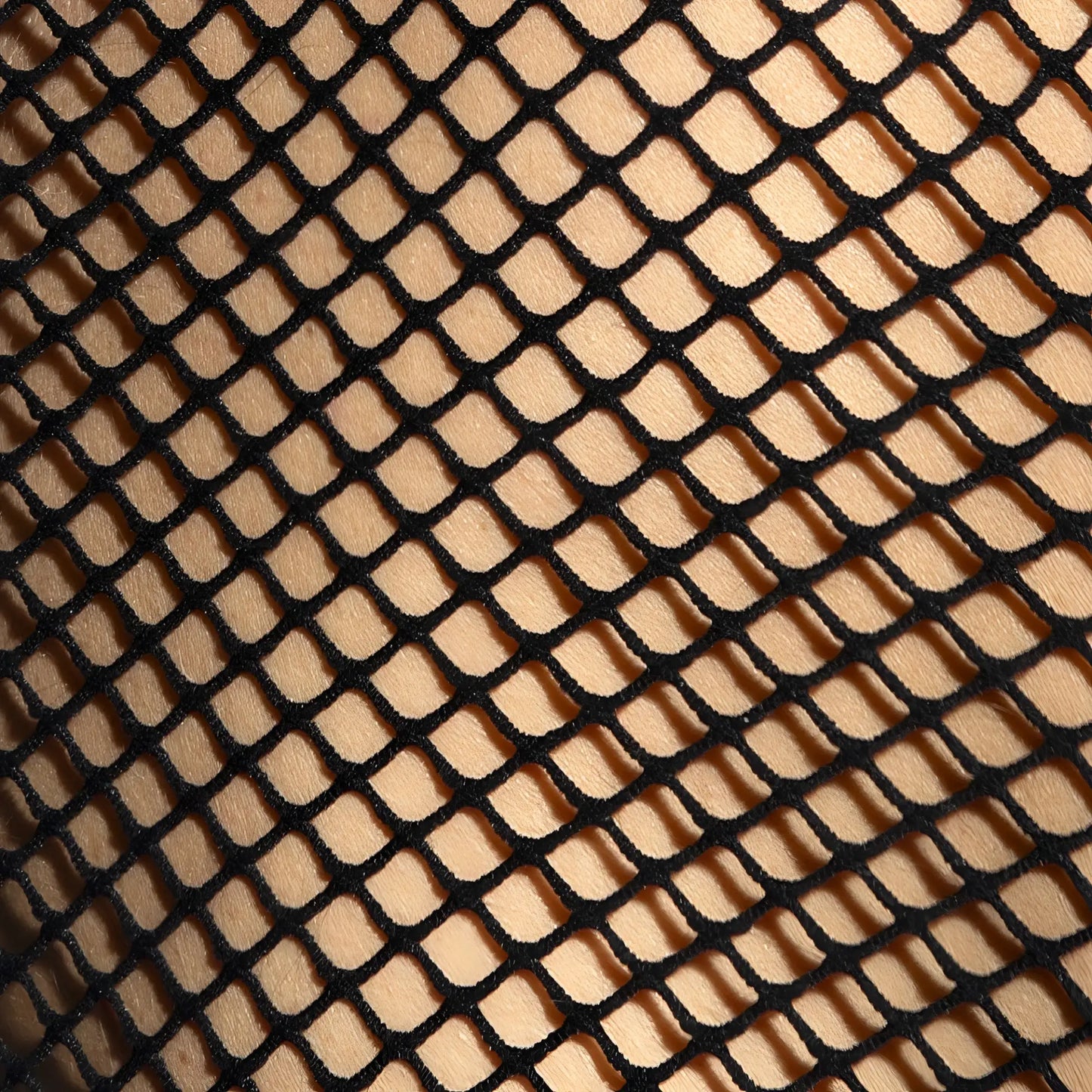 Black fishnet fabric with diamond mesh pattern used in beachy net strap tank top material close up