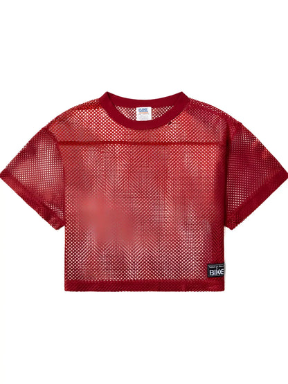 Red mesh crop top with ribbed crew neckline short sleeves and black bike patch in bright red for athletic practice