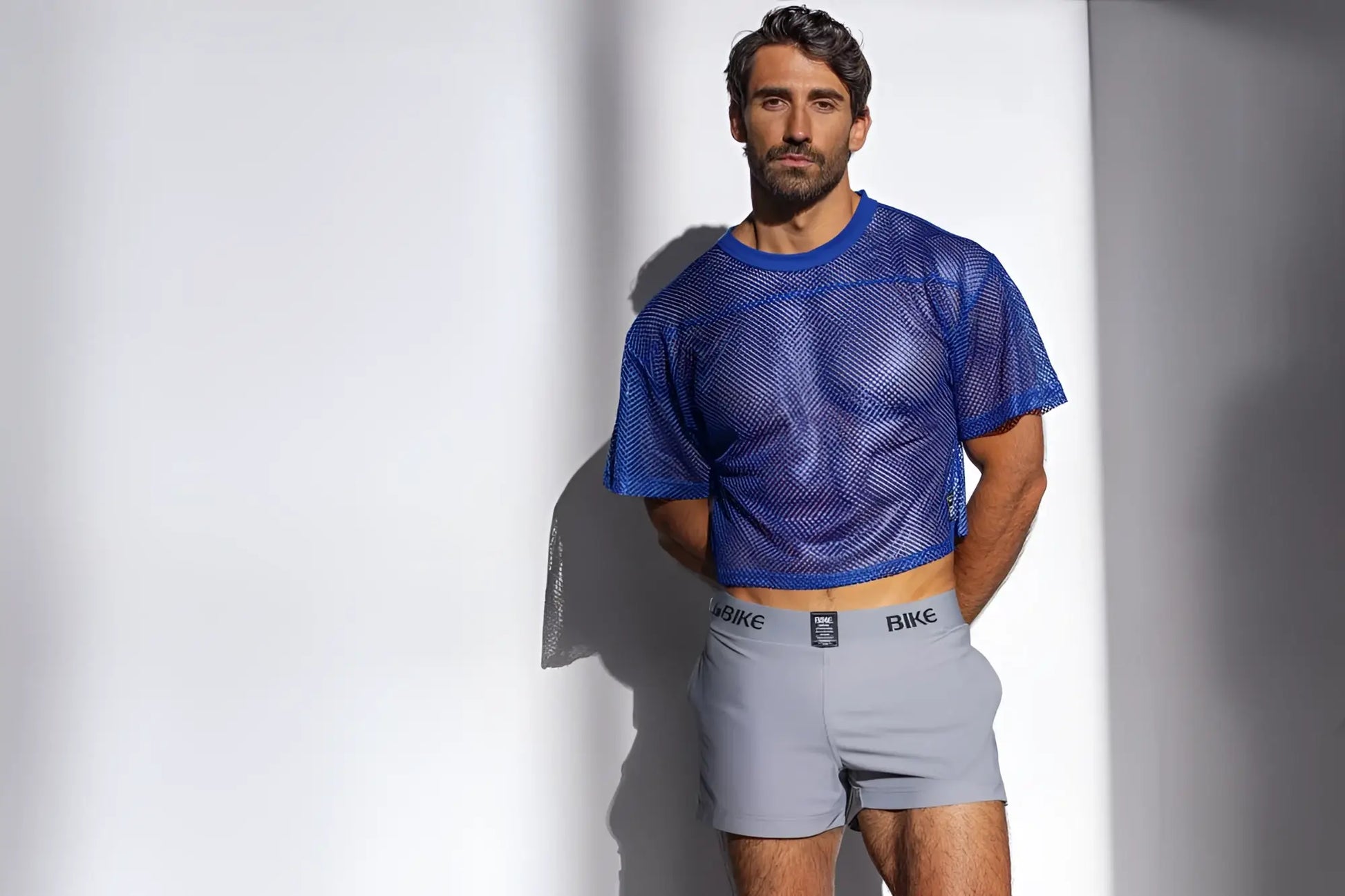 Blue mesh crop top with short sleeves made of breathable fabric for athletic use in royal color