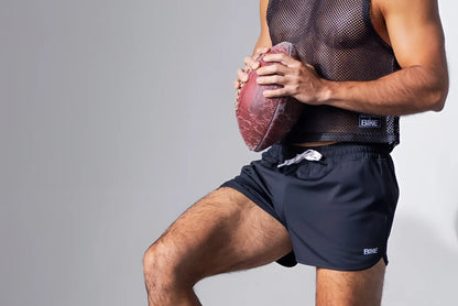 A worn reddish brown american football shown with the black bike athletic bam135 sleeveless mesh practice jersey