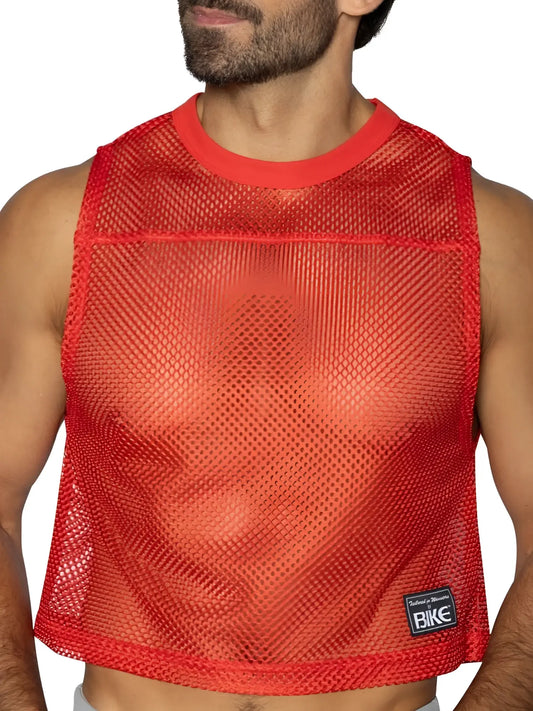 Red mesh crop top with solid red ribbed neckline and hem featuring black bike brand patch on lower right side