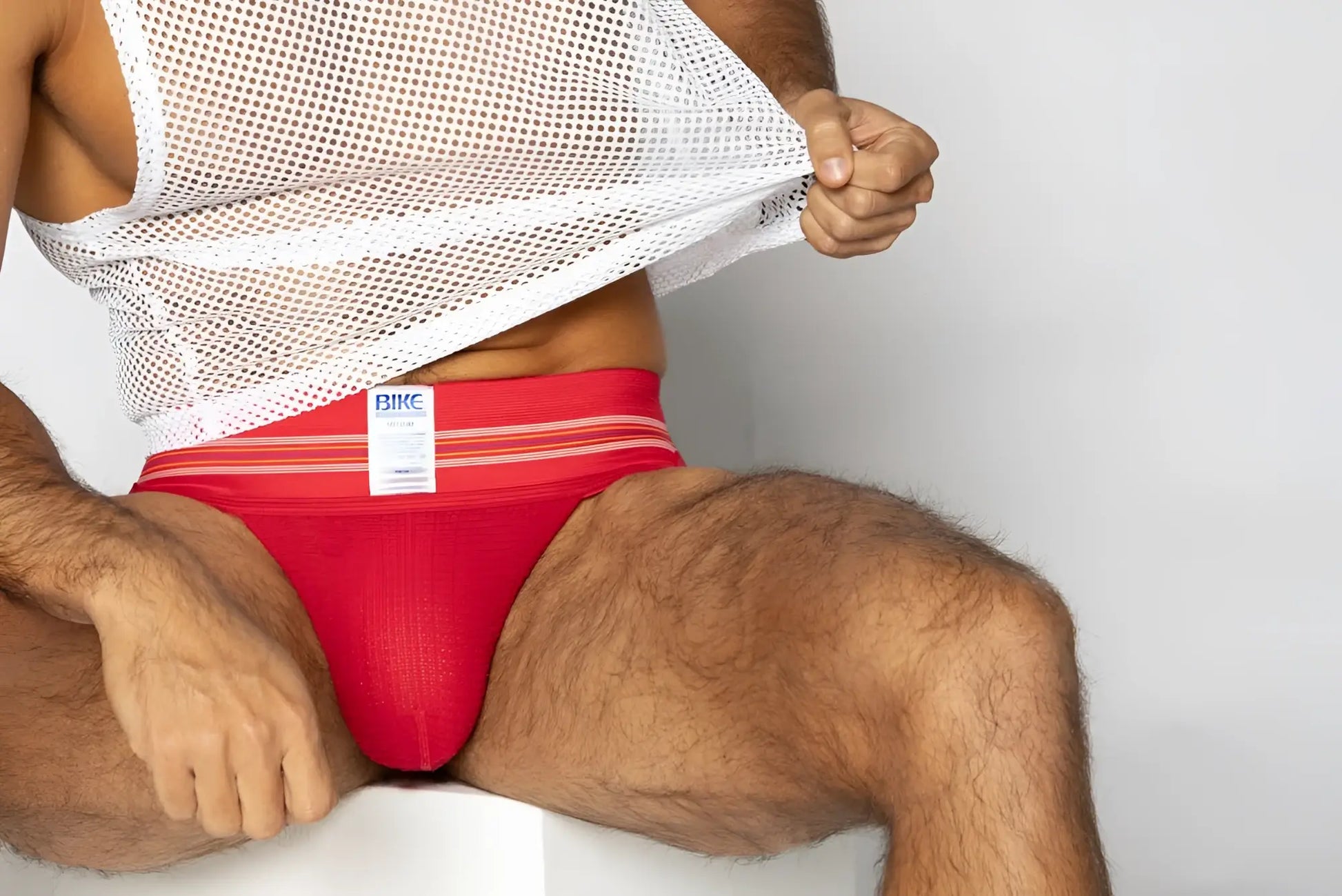 Red bike athletic briefs with white stripes and brand label designed for sports and activewear use