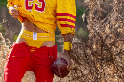 Yellow mesh football jersey with number 23 and a yellow Bike athletic jockstrap.