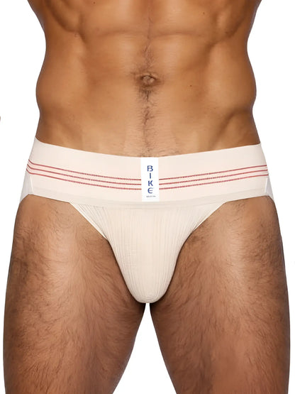 Cream-colored bike athletic briefs with red stripes and a white label in vintage cream classic retro style