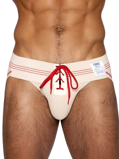 Cream-colored ribbed mens briefs with red lace-up detail and matching waistband stripes from bike athletic vintage line