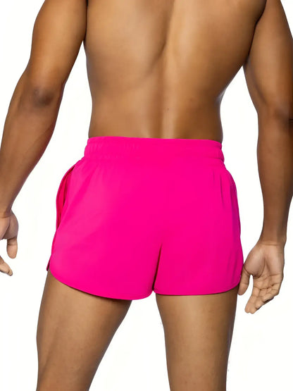 Bright pink BIKE® track short with snug elastic waistband and side pockets designed for athletic use