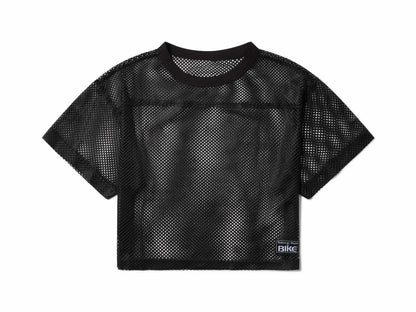 Black mesh crop top with round neckline short sleeves and small rectangular label on lower right side for bike practice jersey