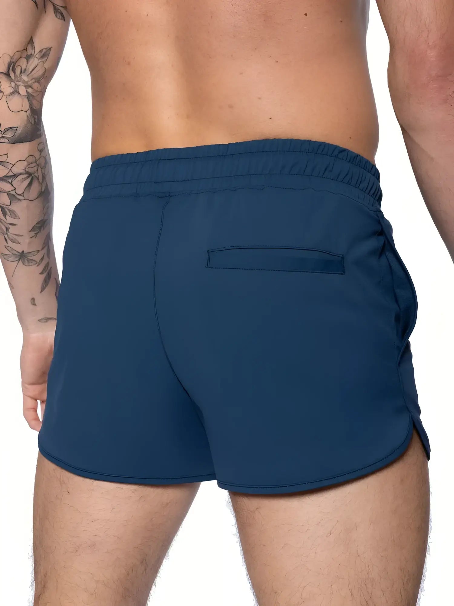 Navy blue BIKE® track short with elastic waistband and single back pocket shown from the back side