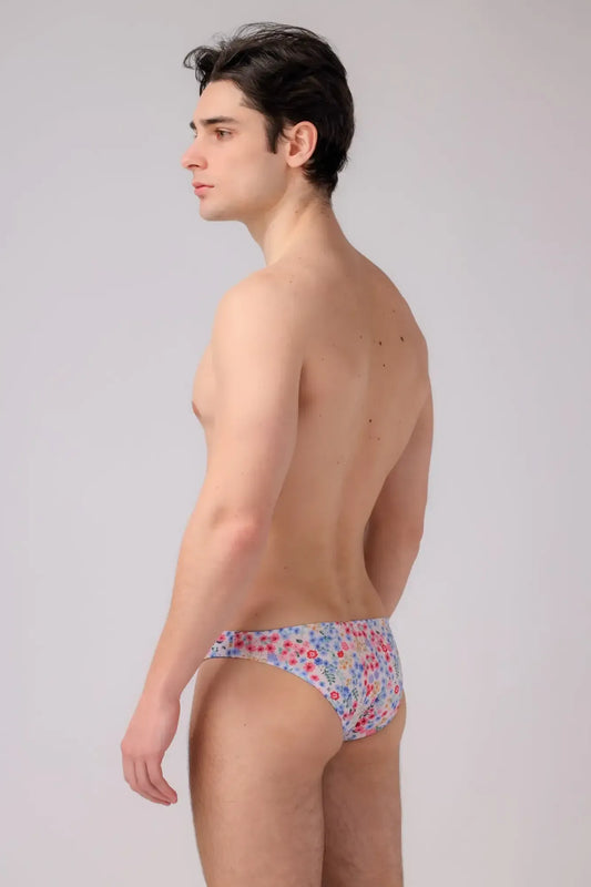 Bikini briefs with a delicate floral pattern in soft pastel hues made from lightweight fabric with elastic waistband