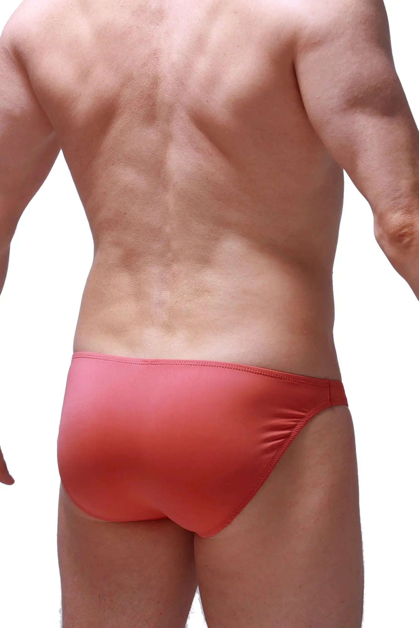Bikini dome blush red form-fitting swim trunks with smooth stretchy fabric and subtle gradient finish